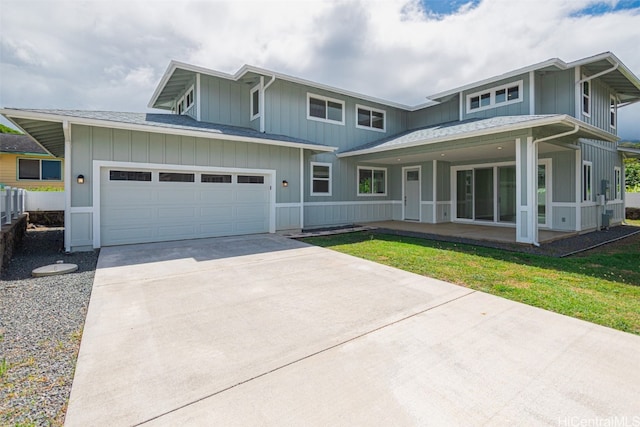 view of front of home with a front yard and a garage