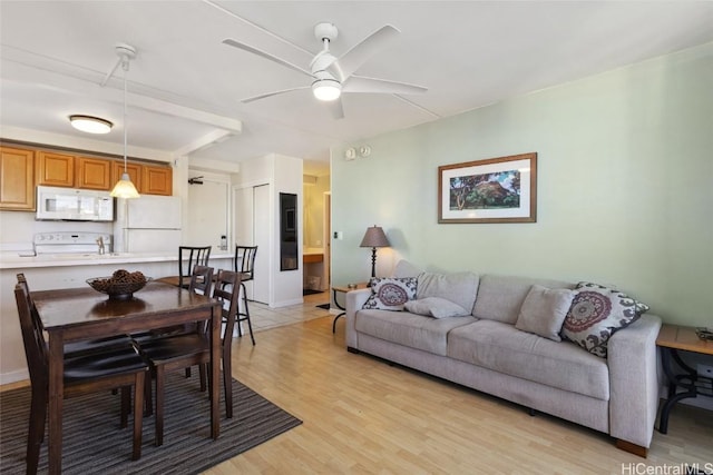 living room featuring ceiling fan and light wood-type flooring