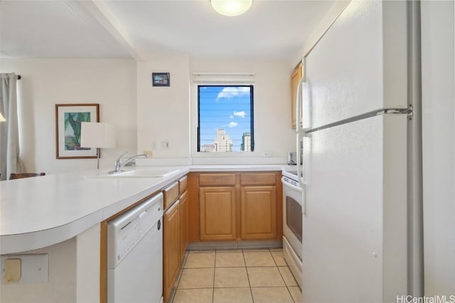 kitchen with white appliances, kitchen peninsula, sink, and light tile patterned floors