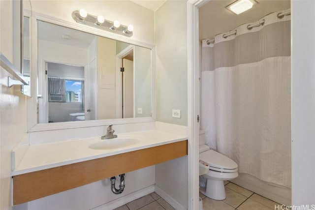 bathroom featuring tile patterned flooring, sink, and toilet