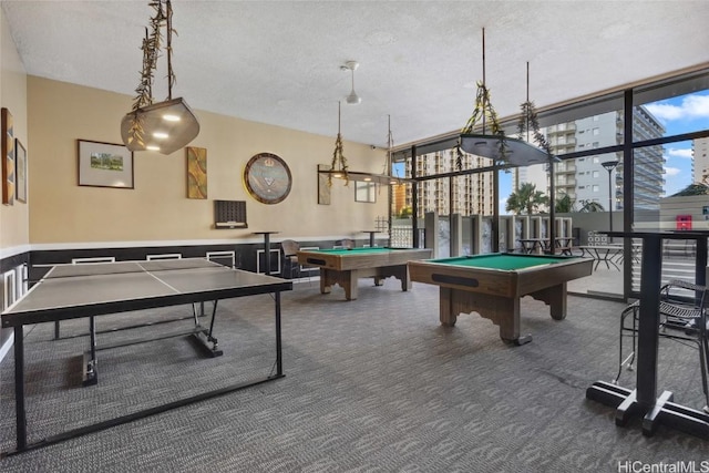 game room featuring billiards, expansive windows, a textured ceiling, and carpet