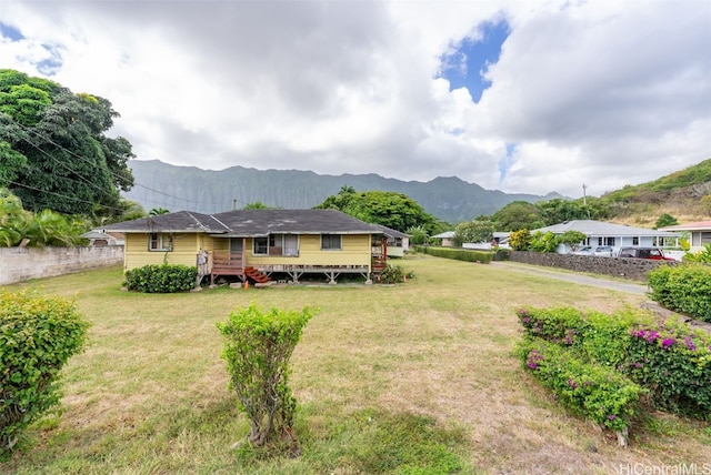 exterior space with a yard and a deck with mountain view