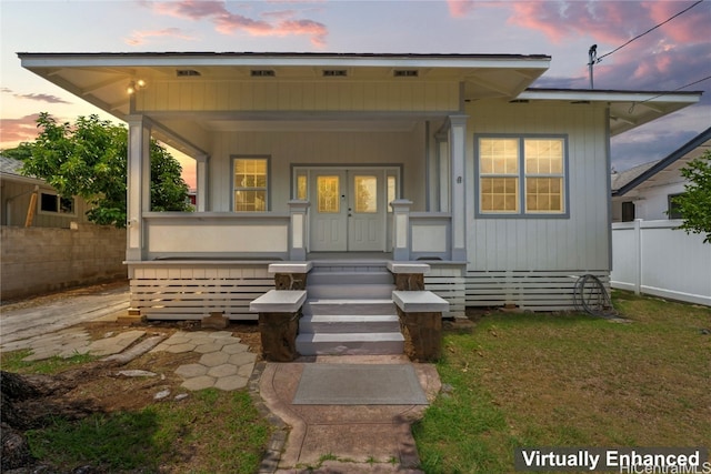 back house at dusk with a porch