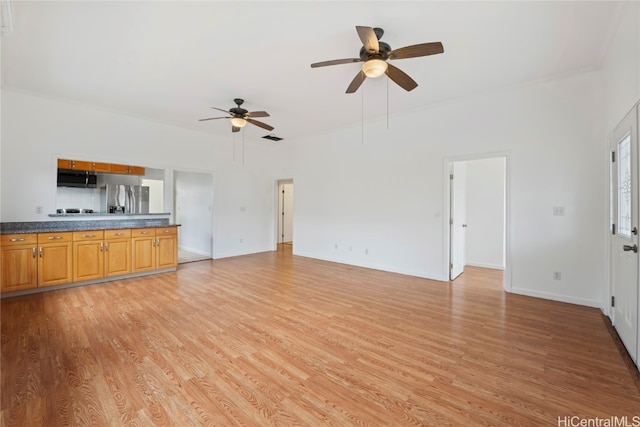 unfurnished living room with light hardwood / wood-style flooring and ceiling fan