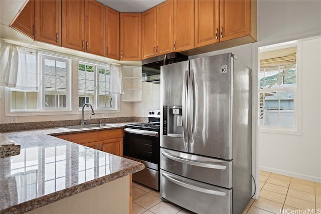 kitchen with light tile patterned flooring, stainless steel appliances, sink, and plenty of natural light