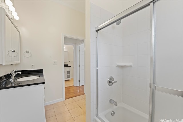 bathroom featuring vanity, enclosed tub / shower combo, and tile patterned flooring