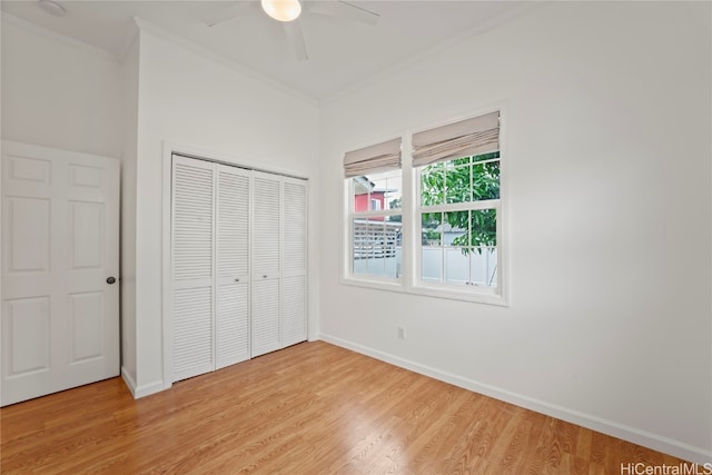 unfurnished bedroom featuring a closet, ceiling fan, ornamental molding, and light wood-type flooring