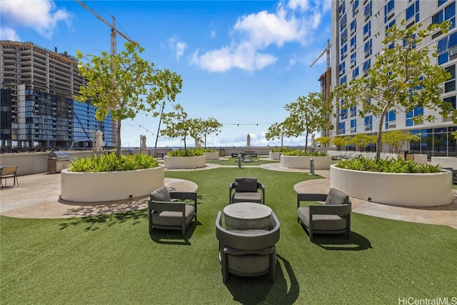 view of home's community with a patio and a lawn