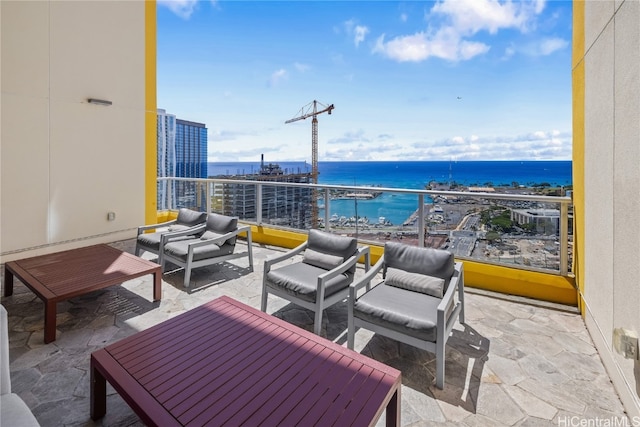 view of patio featuring a water view, an outdoor living space, and a balcony