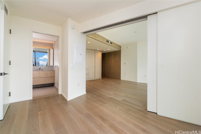 empty room with light hardwood / wood-style flooring