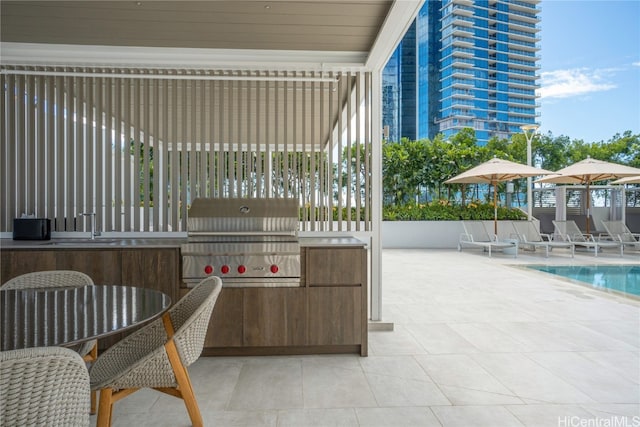 exterior space featuring a community pool and a grill