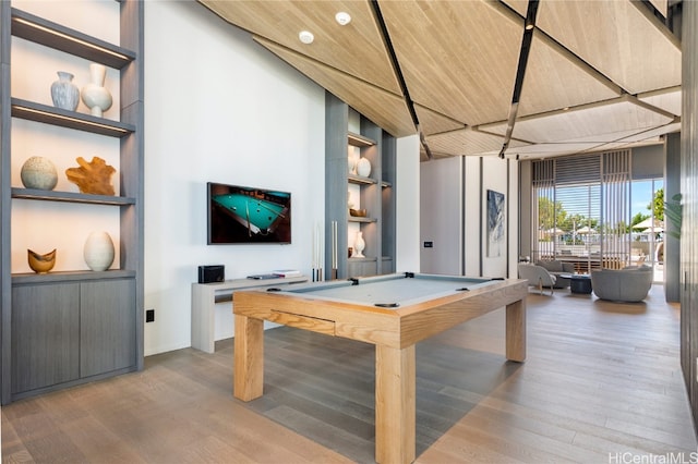 rec room featuring wood ceiling, billiards, wood-type flooring, a high ceiling, and built in features