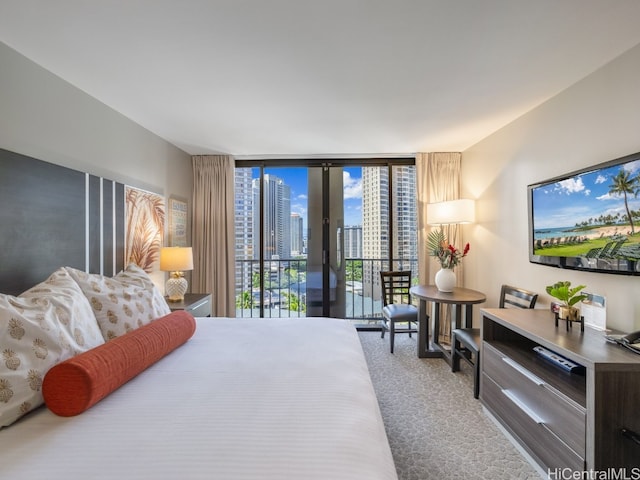 carpeted bedroom featuring a wall of windows and access to exterior