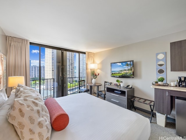 bedroom featuring light carpet, expansive windows, and access to exterior