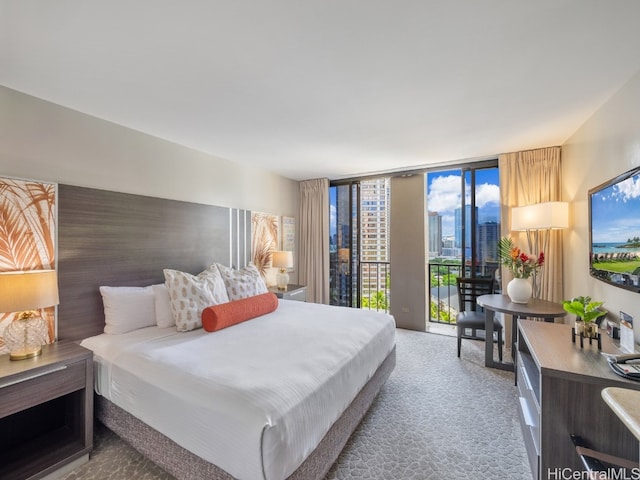 carpeted bedroom with expansive windows and access to exterior