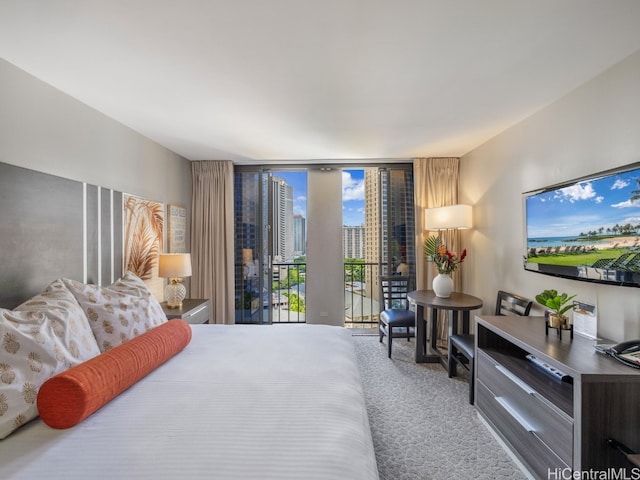 carpeted bedroom with expansive windows and access to outside