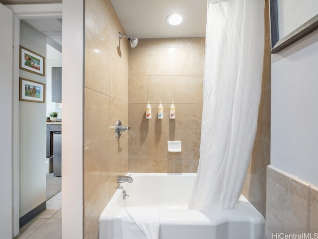 bathroom with tile walls, tile patterned floors, and shower / tub combo