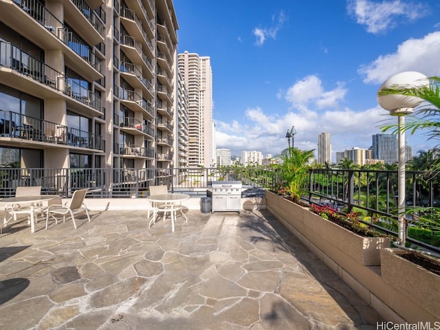 view of patio / terrace with grilling area and a balcony