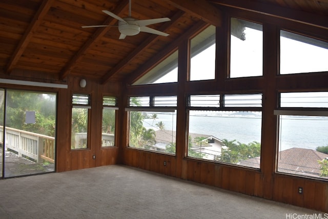 unfurnished sunroom with plenty of natural light, a water view, and lofted ceiling with beams