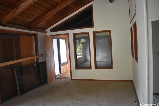 carpeted spare room with lofted ceiling with beams and wooden ceiling