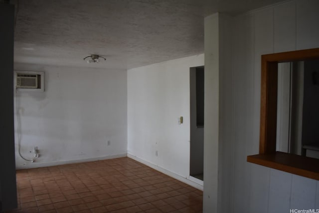 45-55 Lilipuna Rd Unit A, Kaneohe, HI 96744 - empty room with an AC wall unit, baseboards, and a textured ceiling