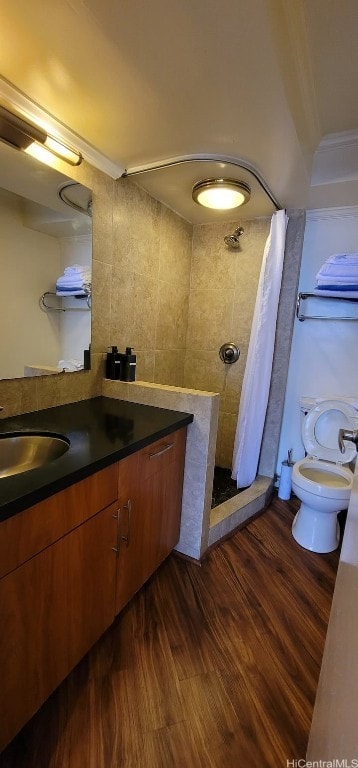 bathroom featuring toilet, a shower with curtain, wood-type flooring, tile walls, and vanity