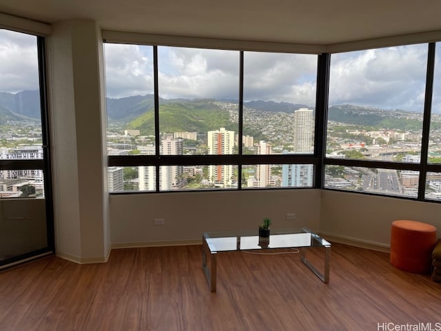 sunroom / solarium with a mountain view and a healthy amount of sunlight