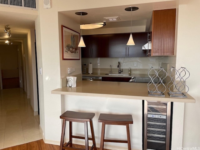 2499 Kapiolani Blvd Unit 3001, Honolulu, HI 96826 - kitchen with beverage cooler, visible vents, a sink, a peninsula, and a kitchen bar