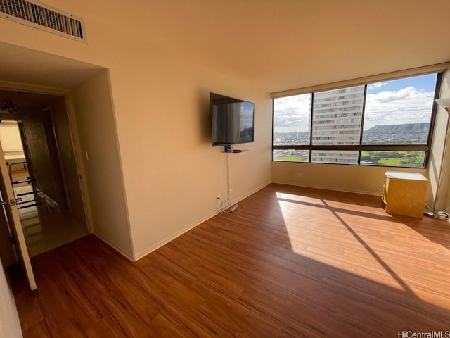 2499 Kapiolani Blvd Unit 3001, Honolulu, HI 96826 - unfurnished living room with baseboards, wood finished floors, and visible vents