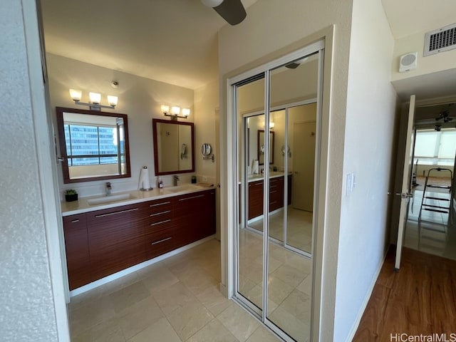 bathroom featuring vanity, hardwood / wood-style floors, and ceiling fan