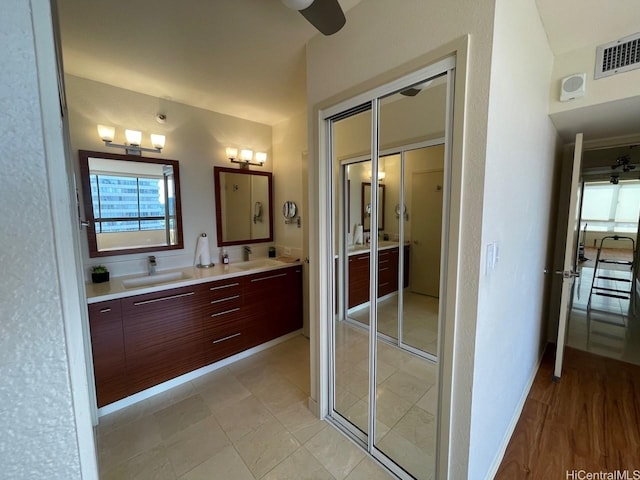 2499 Kapiolani Blvd Unit 3001, Honolulu, HI 96826 - bathroom with double vanity, visible vents, baseboards, and a sink