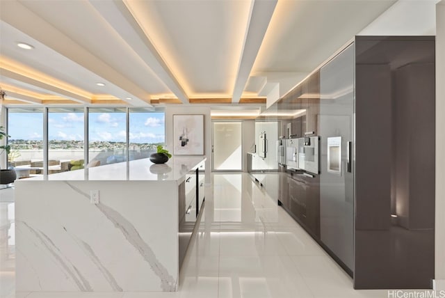 kitchen featuring a large island and beamed ceiling