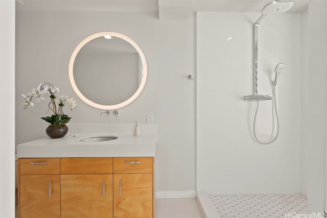 bathroom with a shower, vanity, and tile patterned floors