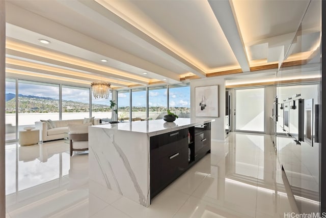 kitchen featuring a chandelier, a mountain view, light tile patterned flooring, and a center island