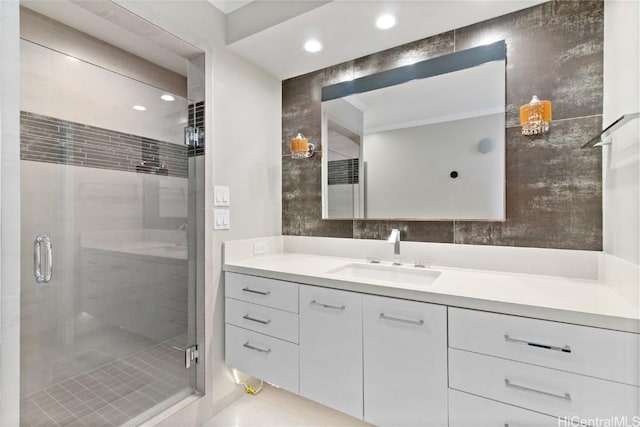 bathroom featuring walk in shower and vanity