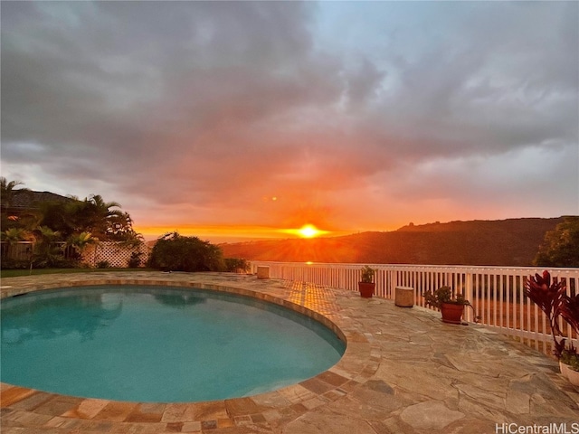 pool at dusk with a mountain view