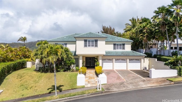 view of front of property with french doors, a garage, and a front yard