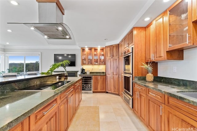 kitchen featuring stainless steel double oven, beverage cooler, black electric stovetop, dark stone counters, and light tile patterned flooring