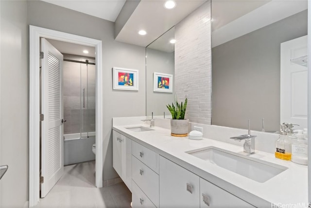 full bathroom featuring toilet, vanity, and enclosed tub / shower combo