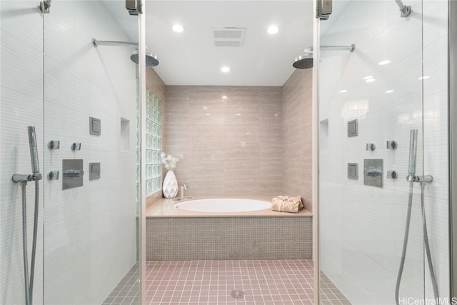 bathroom featuring tile patterned flooring, tile walls, and shower with separate bathtub