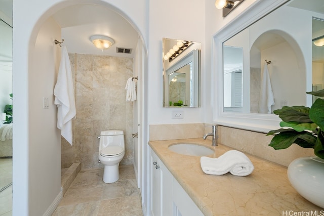 bathroom with vanity, toilet, tile walls, and curtained shower