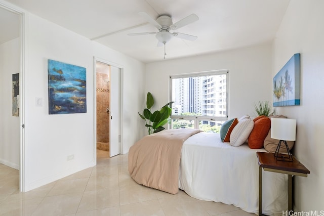 tiled bedroom with ensuite bathroom and ceiling fan