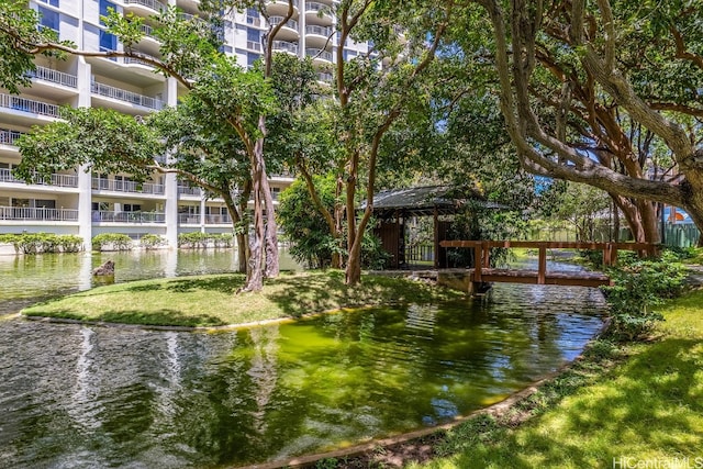 view of dock with a water view and a balcony