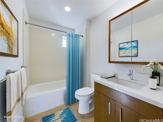 full bathroom featuring vanity, toilet, hardwood / wood-style flooring, and shower / tub combo