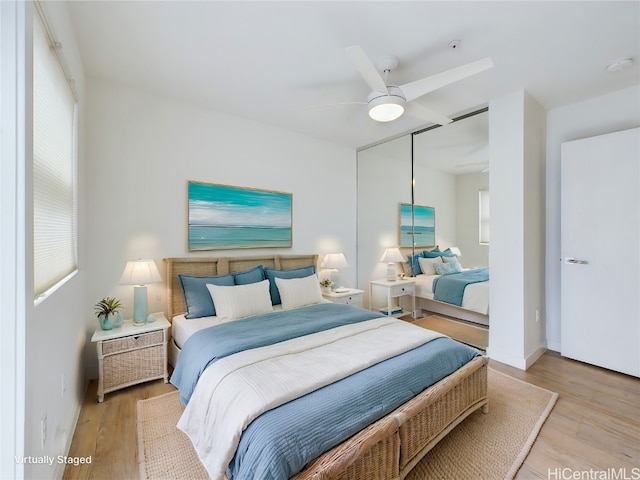 bedroom featuring a closet, ceiling fan, and light hardwood / wood-style flooring