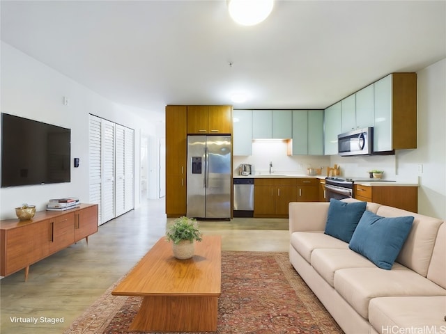 living room with sink and light hardwood / wood-style floors