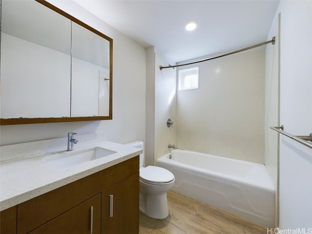 full bathroom featuring vanity, bathtub / shower combination, hardwood / wood-style flooring, and toilet