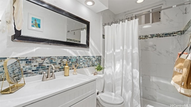 bathroom featuring vanity, curtained shower, backsplash, and toilet