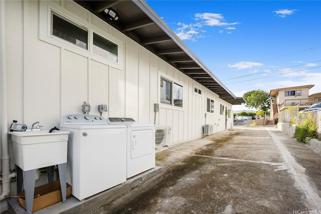 1849 Vancouver Pl, Honolulu, HI 96822 - view of home's exterior with washing machine and dryer, ac unit, board and batten siding, and a sink