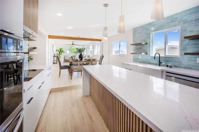 1849 Vancouver Pl, Honolulu, HI 96822 - kitchen featuring stainless steel appliances, light wood-style flooring, a sink, modern cabinets, and open shelves